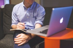 Canva - Man Sitting on Couch in Front of Macbook