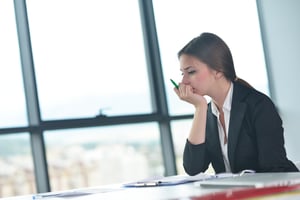 Portrait of tired young business woman at the office