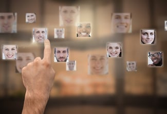 Finger selecting futuristic interface showing faces