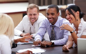 Happy business people sitting around the table at the meeting